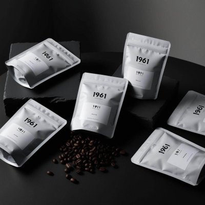 create a image for coffee beans pouches to showcase on website. brand name is 1961 coffee and colour combinations should be black and white